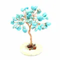 Detailed view of handmade copper wire wrapped turquoise gemstone tree on a stone base - Turquoise