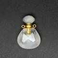 Detailed view of faceted clear natural stone perfume bottle pendant with gold metal loops - White Crystal / Gold Accessories