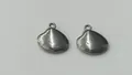 Close-up of polished stainless steel shell pendants for DIY jewelry making projects. - 13.65x14.35x4.17mm