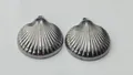 Close-up detail showing the ribbed texture of polished stainless steel shell charms - 27.9x24.85x6.75mm