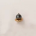 Close-up of a black and gold stainless steel bell pendant for DIY jewelry - Black Bell