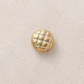 Close-up of a gold-plated stainless steel round bead with quilted pineapple pattern - White Round