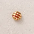 Macro view of a golden stainless steel bead featuring red pineapple bun pattern - Red Round