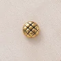 Macro detail of a gold-plated stainless steel quilted bead for DIY jewelry making. - Black Round