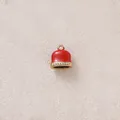 Close-up of a red enamel bell charm with sparkling rhinestone trim and a gold loop. - Red Bells with Rhinestones