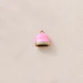 Detailed close-up of pink enamel bell pendant with gold plating and sparkling rhinestones - Pink Bells with Rhinestones