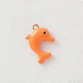 Close-up of bright orange dolphin enamel charm with gold-plated loop for DIY jewelry - Orange Dolphin