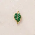 Green enamel leaf pendant accessory in golden stainless steel with intricate dot details - Gold Edge Green Leaf Pendant