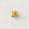 Detailed macro shot of a bird-shaped gold-plated enamel bead for DIY jewelry making - Yellow Bird