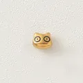 Detailed macro view of a gold-plated stainless steel cartoon animal bead for DIY jewelry - Black Eyed Pig (Style 6)