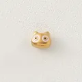 Detailed view of a golden stainless steel cartoon cat bead with pink enamel eyes - Pink Eyed Cartoon Cat (Style 7)