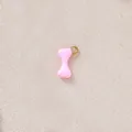Detailed macro view of pink hourglass charm with gold plated loop for DIY necklaces - Pink Bone