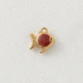 Macro view showing the fine texture and red glitter enamel of the gold fish charm. - Red Fish