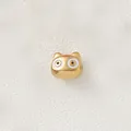 Macro detail of a gold-plated cartoon animal bead featuring white enamel eye accents. - White Eyed Cartoon Cat (Style 11)