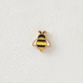 Detailed view of a small 18K gold-plated bee charm with colorful enamel dripping oil. - Bee