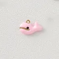 Close-up detail of a cute pink enamel whale charm with gold-plated loop for DIY jewelry - Pink Whale