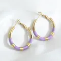Gold-plated stainless steel bamboo hoop earrings with purple enamel drip finish. - Purple