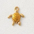 Macro detail of a gold-plated stainless steel sea turtle charm with yellow enamel shell. - Golden Turtle