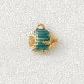 Macro view of a gold-plated fish pendant with green enamel stripes for DIY jewelry - Light Blue Fish