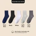 Five pairs of men's solid color mid-calf cotton crew socks in assorted neutral tones - Crew Socks / Multicolor
