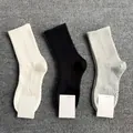 Breathable men's ribbed socks in white, black, and grey neutral colors set. - Long Massage Sole / Gray