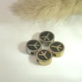 Close-up view of stainless steel round beads with black oil drop and symbol pattern - Steel / Rune Variant Style (PJ13-10)