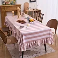 Pink and white striped velvet tablecloth with ruffled edges in a cozy dining setting. - 100x140cm / Beige Striped Ruffle