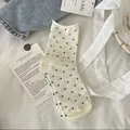 Cream-colored mid-calf cotton socks with black polka dots and rolled lettuce edge - One Size / Cream