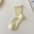 Minimalist cream-colored crew socks featuring black polka dots and stylish rolled cuff design - One Size / Milk Yellow