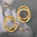 Elegantly designed hammered golden titanium steel double-hoop earrings for a modern look. - Hammered Double Ring Interlocking Style (UB614) / One Pair / Gold