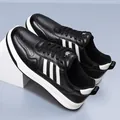 Fashionable black leather men's sneakers with white stripes and casual flat sole - 38 / Black