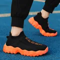 Breathable black fly-knit sock shoes featuring vibrant orange wavy soles and sport text - 36 / Black Orange Floral