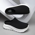 Stylish black knit mule sneakers featuring a thick white platform sole for casual comfort - Black and White