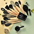 Comprehensive 34-piece black silicone kitchen utensil set with wooden handles - Black