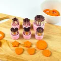 Stainless steel vegetable cutter set with pink handles and shaped carrot slices on board - 6-Piece Set / Pink