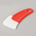 Red and white silicone kitchen scraper tool for grease and food residue cleaning. - Red