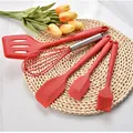 Red 5-piece silicone kitchen utensil set on a woven mat with decorative yellow tulips. - Bracelets Group / Red