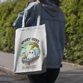 Outdoor lifestyle view of a women's canvas tote bag with spooky ghoul summer print - Ghoul Summer Beach Style (20) / 35*40cm
