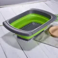 Collapsible green and grey silicone colander with extendable handles for sink drainage - Green