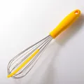 Durable stainless steel manual balloon whisk featuring an ergonomic yellow handle - Whisk