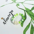 Fresh green and white bohemian beaded ring featuring a delicate white flower charm - Green White Mix with Cream Flower (Style 39)