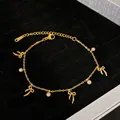 Detailed view of gold bow charm bracelet with crystals on black background - Bowknot (YMB632) / Gold