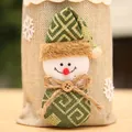 Macro view of a cute snowman decoration on a burlap Christmas wine bottle gift bag - Beige Snowman Style