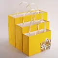 Bright yellow paper gift bags with rivets and cute cartoon dog print in three sizes - Cute Dog Style / L