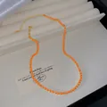 Leichte luxuriöse goldene Tenniskette mit leuchtend orangefarbenen Kristallen im Etui - Orange