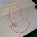 Elegant gold-toned tennis necklace featuring vibrant fuchsia pink crystals for women - Deep Pink
