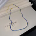 Elegant gold plated chain necklace featuring a row of sparkling blue crystal rhinestones - Blue
