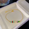 Pulsera con inicial 'S' bañada en oro con piedras preciosas de colores y cristales - S