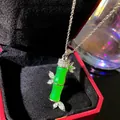 Close-up detail of a luxury green faux jade bamboo pendant necklace in a red jewelry box - Emerald Green Ru Yi Bamboo (W1179-1)