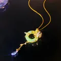 Detailed macro view of a green jade-like donut pendant with gold floral crystal accents - Auspicious Cloud Ping'an Buckle (W1184)